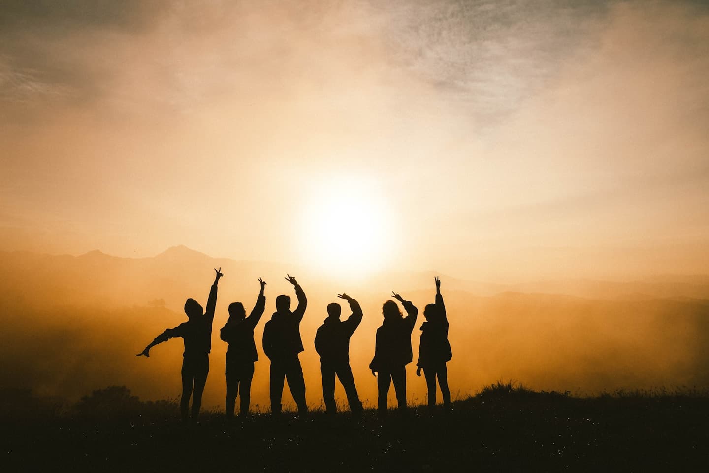 Friends laughing together at sunset while traveling
